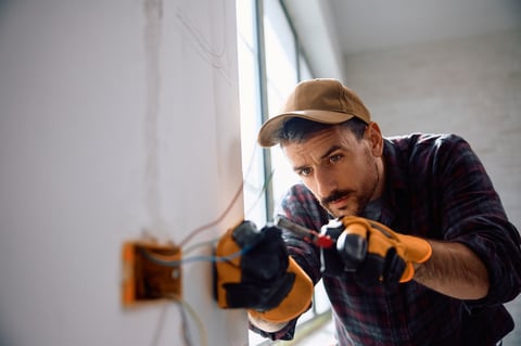 Mid adult electrician working at construction site